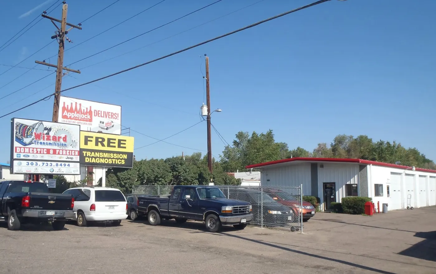 Wizard Transmission's shop with its roadside sign advertising free transmission diagnostics
